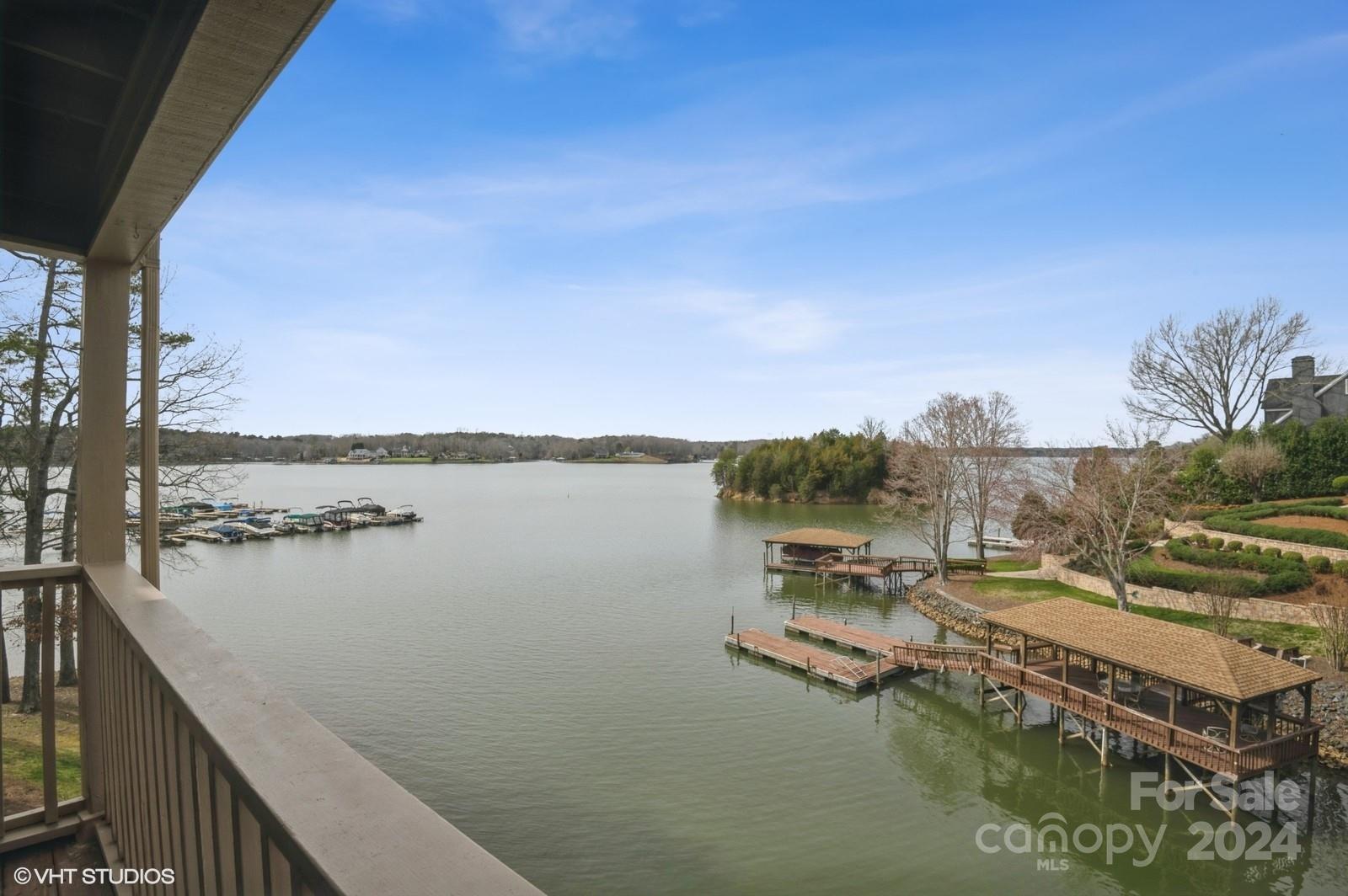 13822 Queens Harbor Road, Unit H Charlotte, NC 28278 - Photo 2 of 37 a view of a lake with a big yard