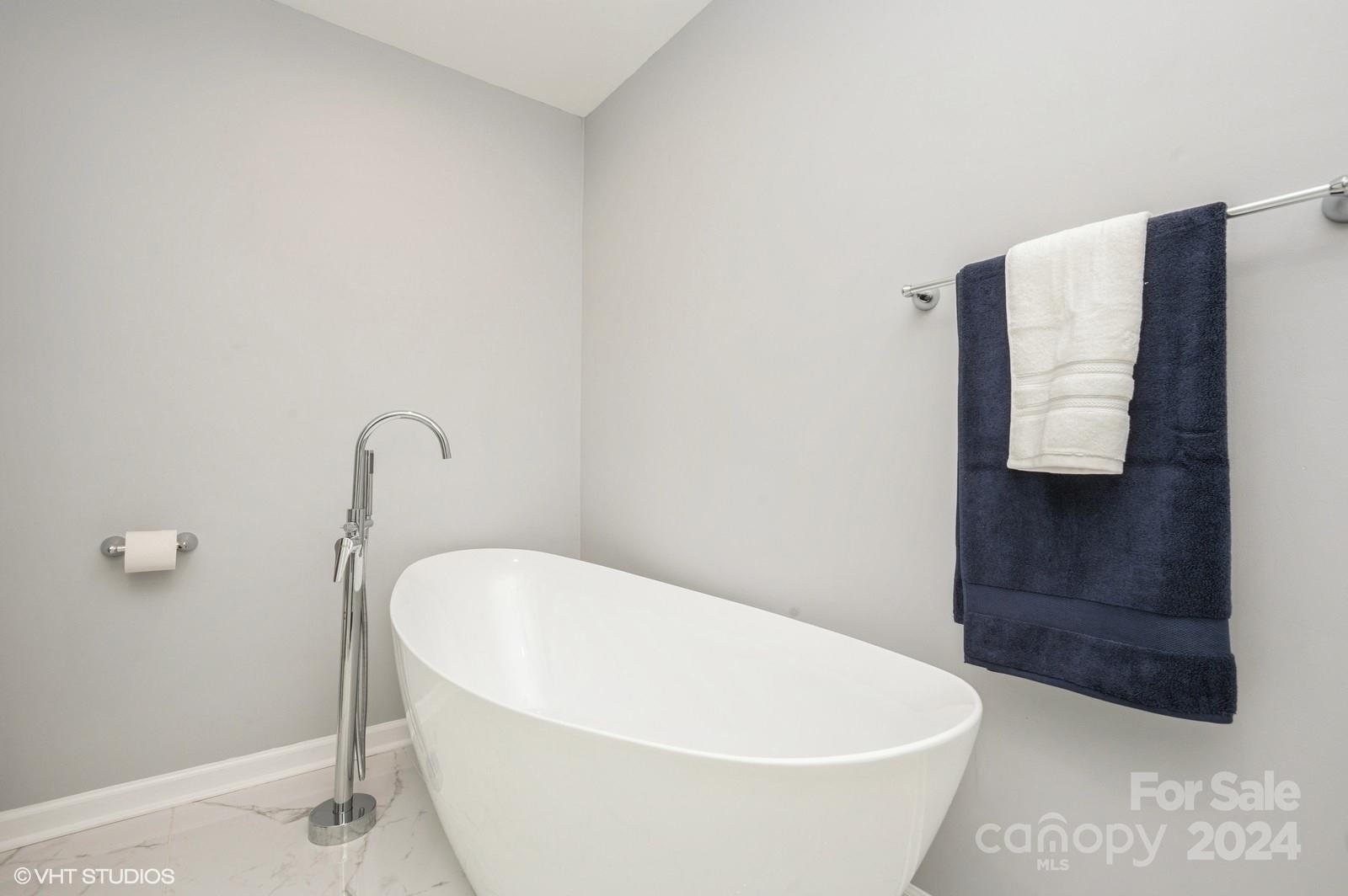 13822 Queens Harbor Road, Unit H Charlotte, NC 28278 - Photo 21 of 37 a white bath tub sitting in a bathroom