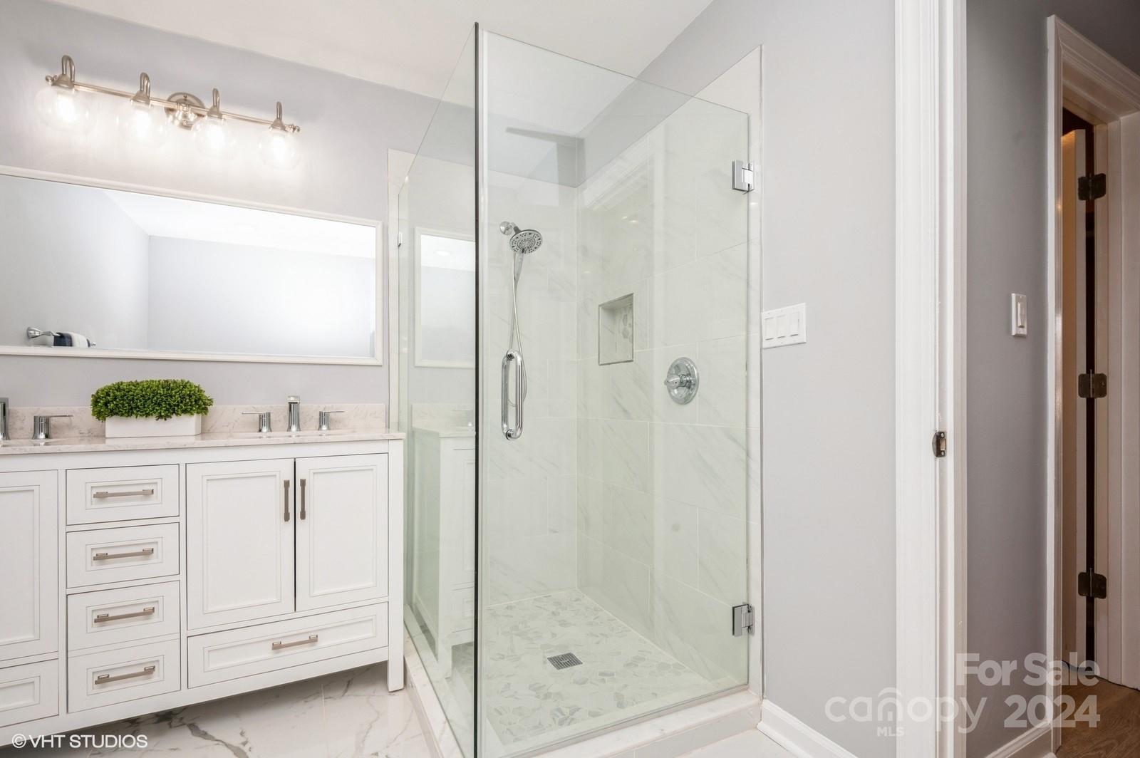 13822 Queens Harbor Road, Unit H Charlotte, NC 28278 - Photo 22 of 37 a bathroom with a shower sink and mirror