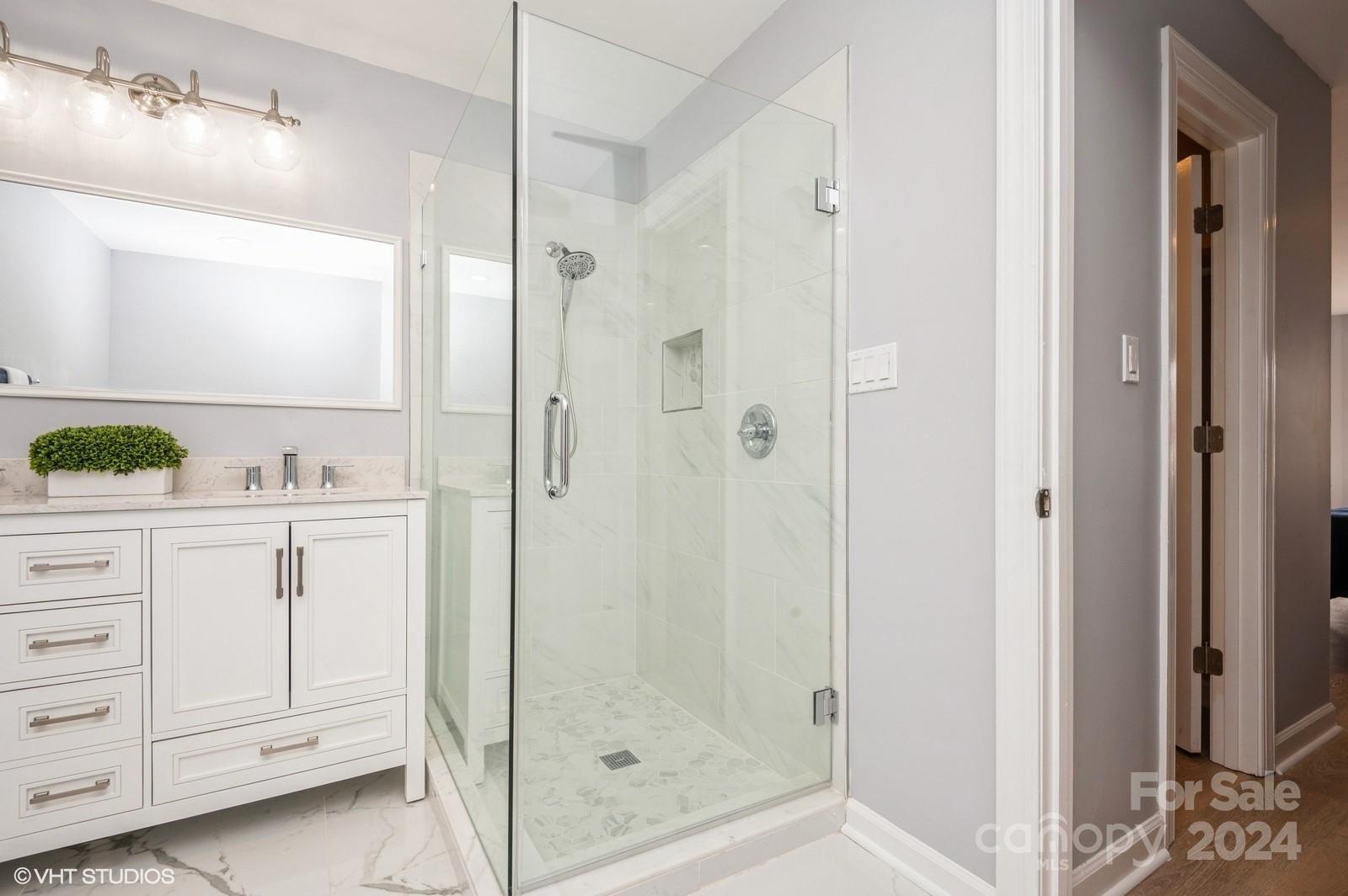 13822 Queens Harbor Road, Unit H Charlotte, NC 28278 - Photo 23 of 37 a bathroom with a shower sink and mirror