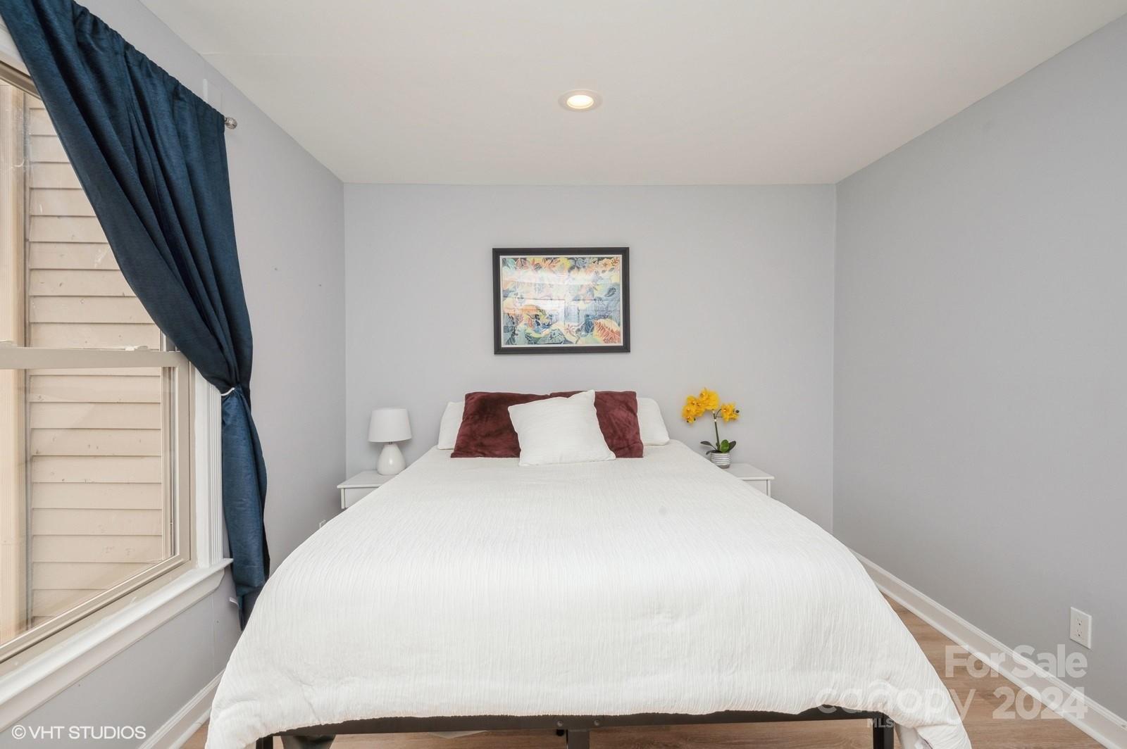 13822 Queens Harbor Road, Unit H Charlotte, NC 28278 - Photo 27 of 37 a bedroom with a large bed and a window
