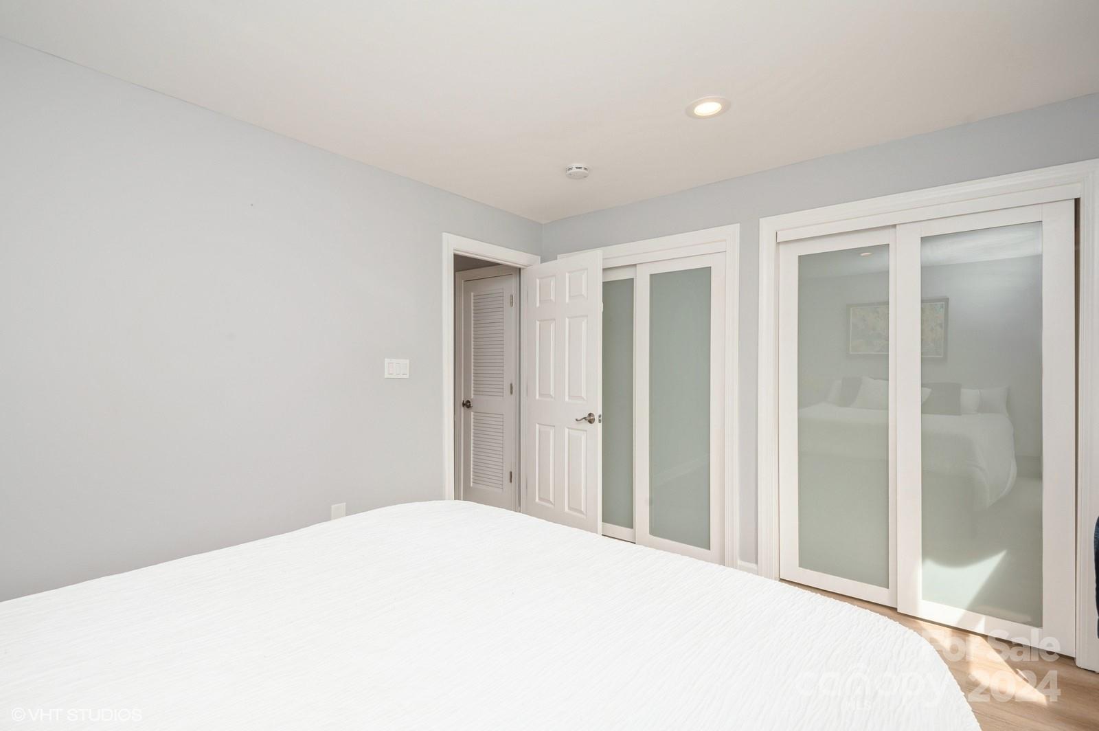 13822 Queens Harbor Road, Unit H Charlotte, NC 28278 - Photo 28 of 37 a bedroom with a bed and a window