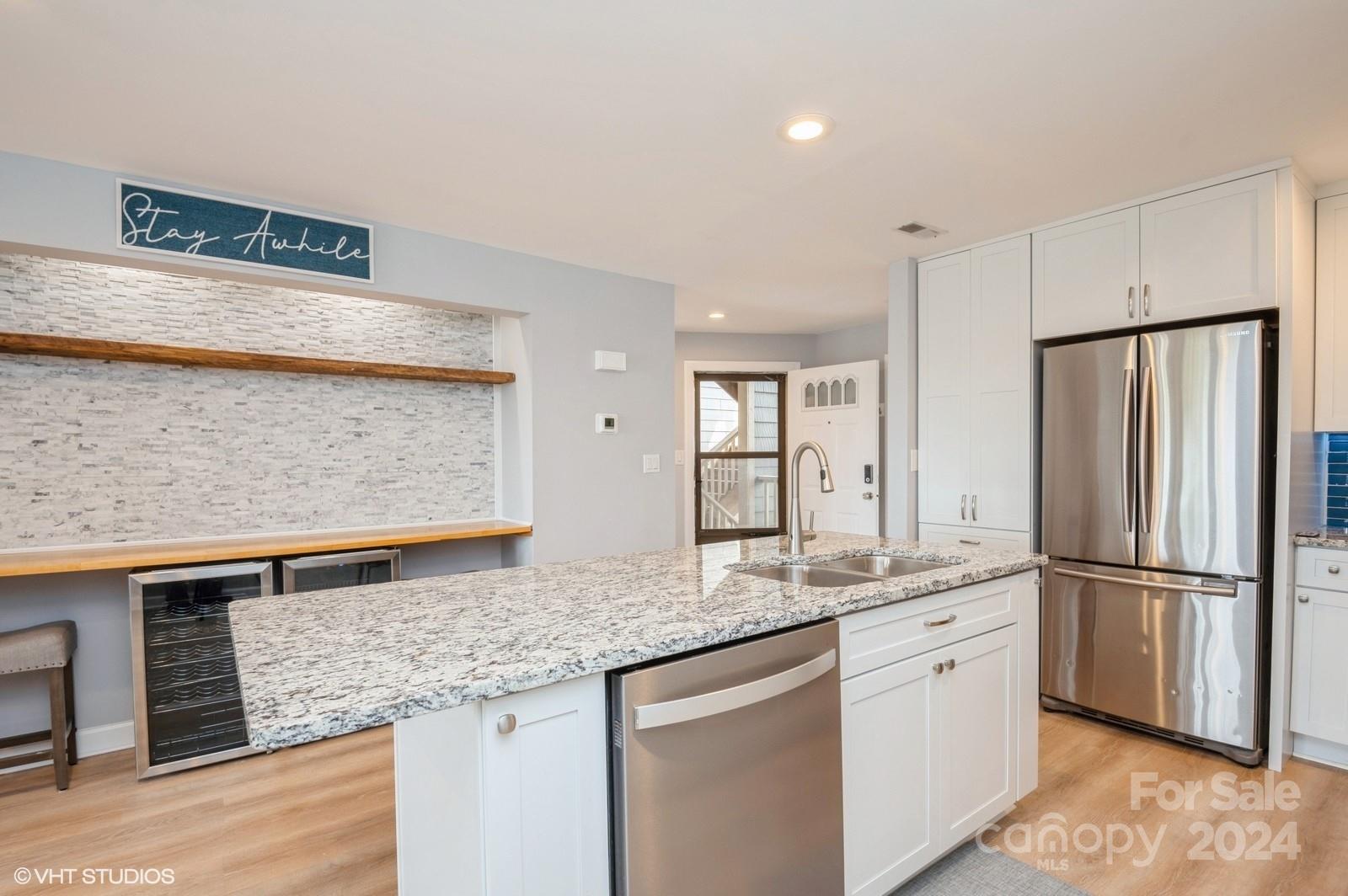 13822 Queens Harbor Road, Unit H Charlotte, NC 28278 - Photo 8 of 37 a kitchen with stainless steel appliances granite countertop a refrigerator and a sink