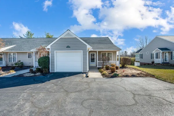 a view of a house with backyard and porch