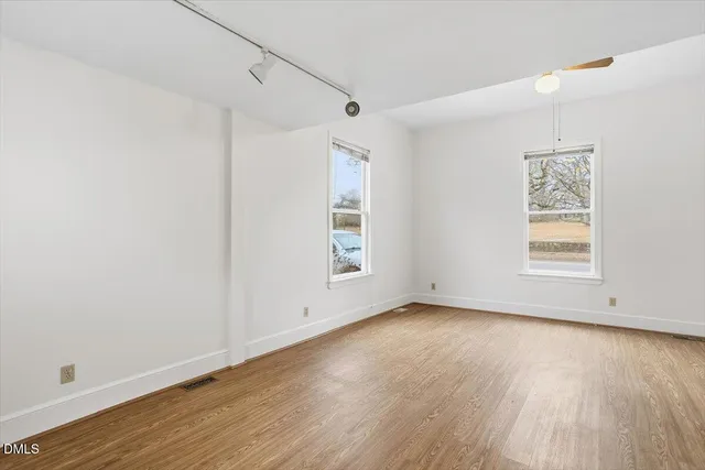 wooden floor in an empty room with a window