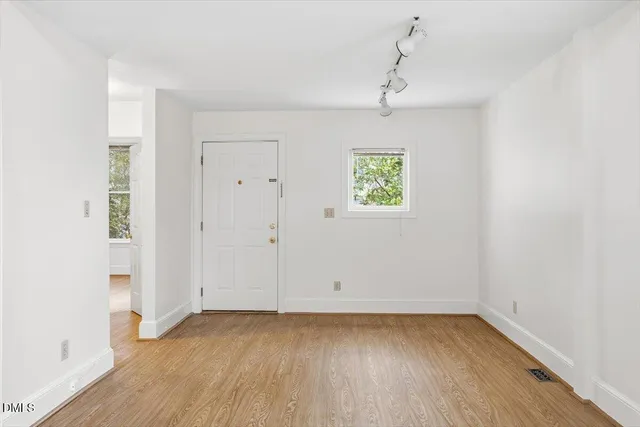 a view of an empty room with ceiling fan