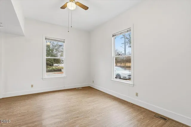 wooden floor in an empty room with a window