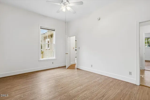 a utility room with a sink a toilet and a window