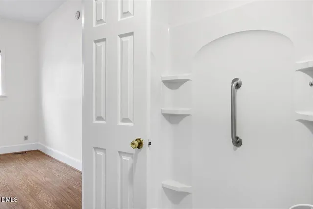 wooden floor in an empty room with a window