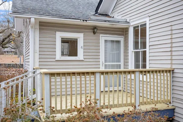 a view of a house with a door and wooden floor