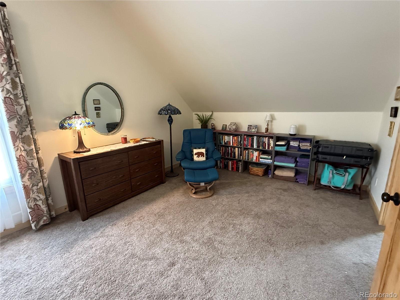 406-449 Schierl Road Fort Garland, CO 81133 - Photo 30 of 50 a bed room with furniture and a fireplace