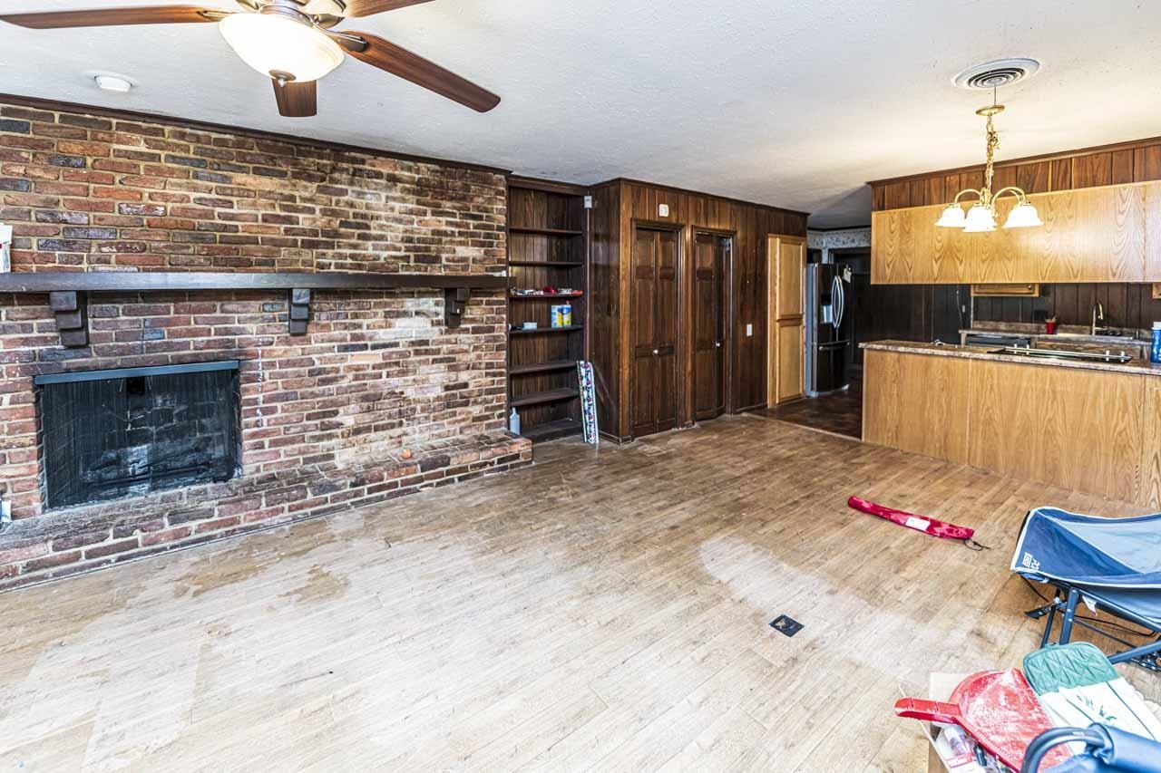 725 Old Brownsville Road Ripley, TN 38063 - Photo 7 of 40 a large kitchen with a stove and a wooden floor