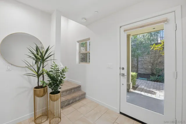 a flower pot with a potted plant in front of a window