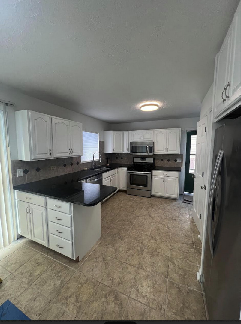 20564 Elizabeth Avenue Prairie View, IL 60089 - Photo 2 of 9 a kitchen with stainless steel appliances a refrigerator a stove a sink a microwave and a refrigerator