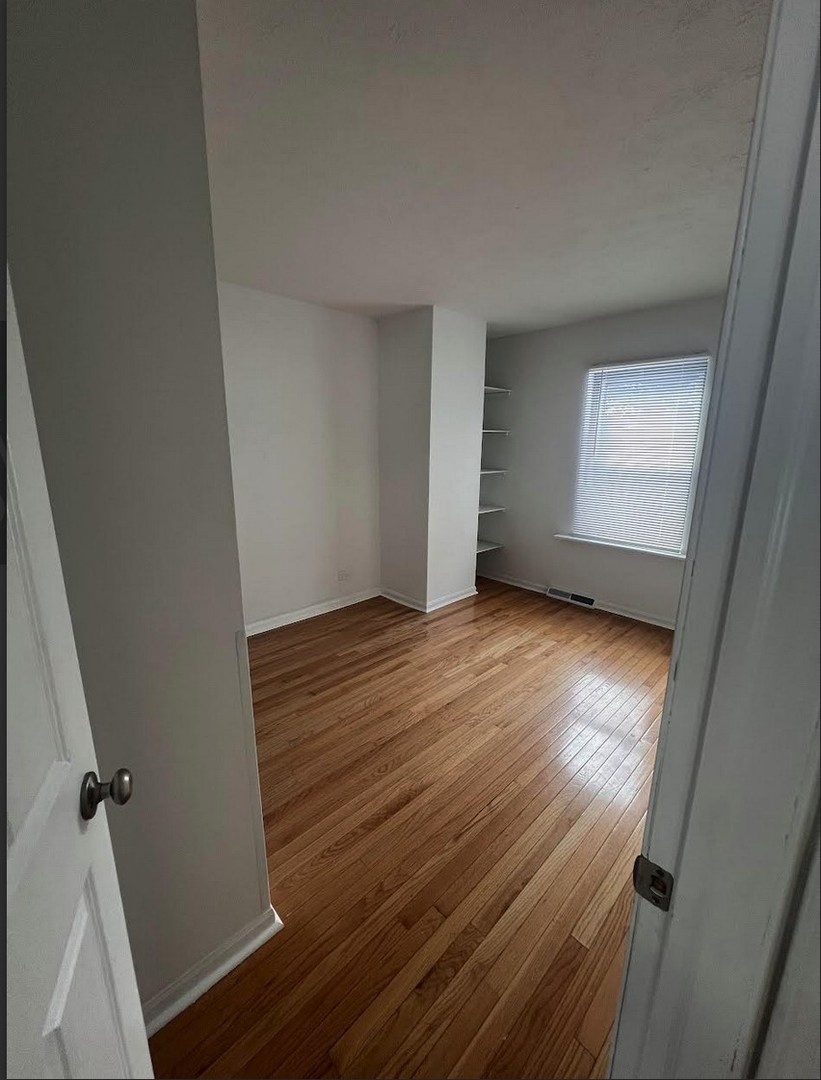 20564 Elizabeth Avenue Prairie View, IL 60089 - Photo 5 of 9 an empty room with wooden floor and windows