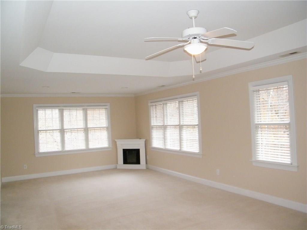 8413 Case Ridge Drive Oak Ridge, NC 27310 - Photo 19 of 30 Electric fireplace anchors the sitting area of master bedroom