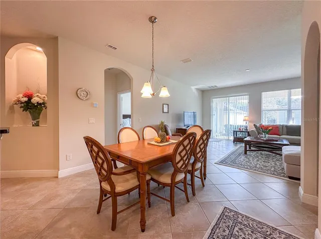 a dining room with furniture and window