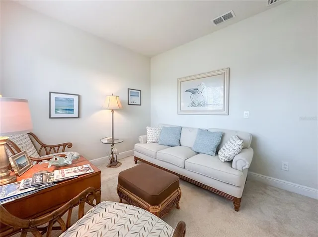 a living room with furniture and a lamp