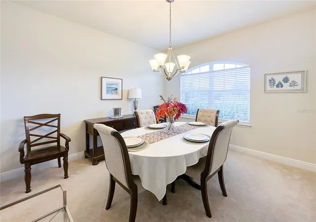 a view of a dining room with furniture and chandelier