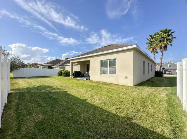 a view of a house with a backyard