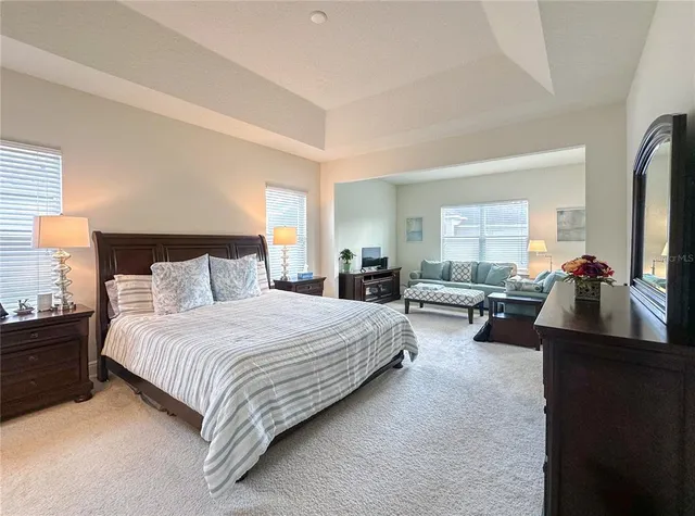 a bedroom with bed couch and window