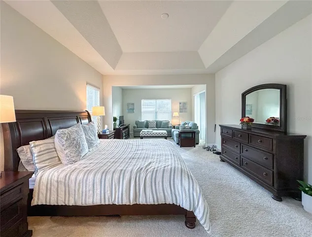 a bedroom with a bed and a dresser in it