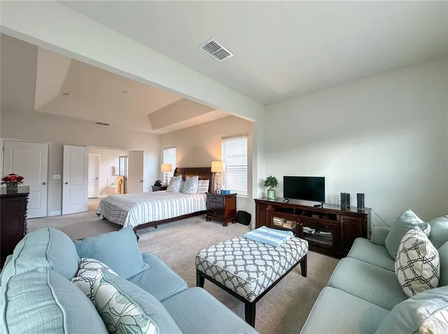 a bedroom with a bed and a couch