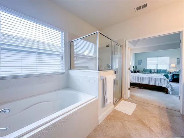 a spacious bathroom with a tub and shower