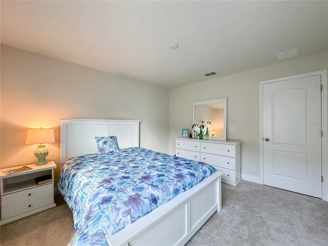 a bedroom with a bed and a dresser in it