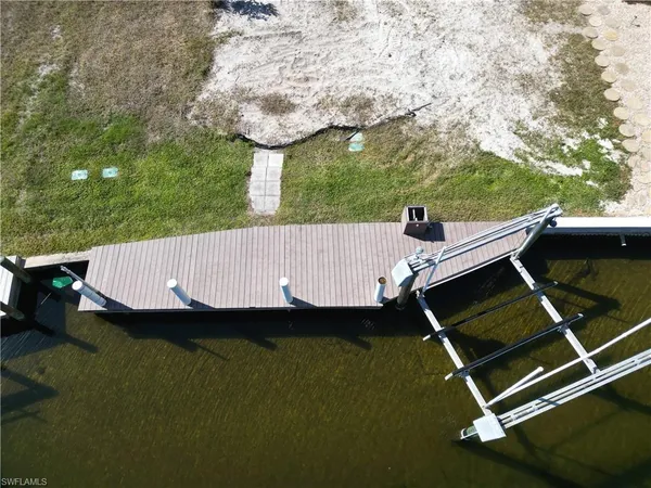 an aerial view of a house with swimming pool garden and bench