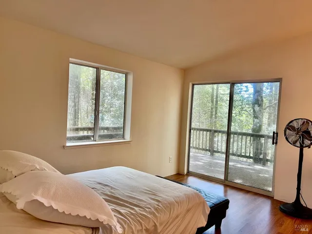 a bedroom with a large bed and a large window