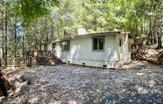 a white house that has a tree in front of it