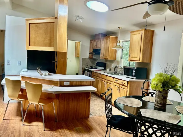 a kitchen with stainless steel appliances kitchen island granite countertop a sink and cabinets