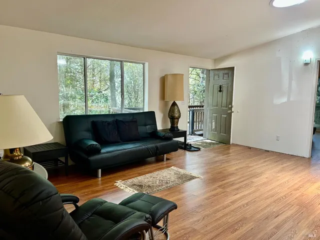 a living room with furniture and a large window