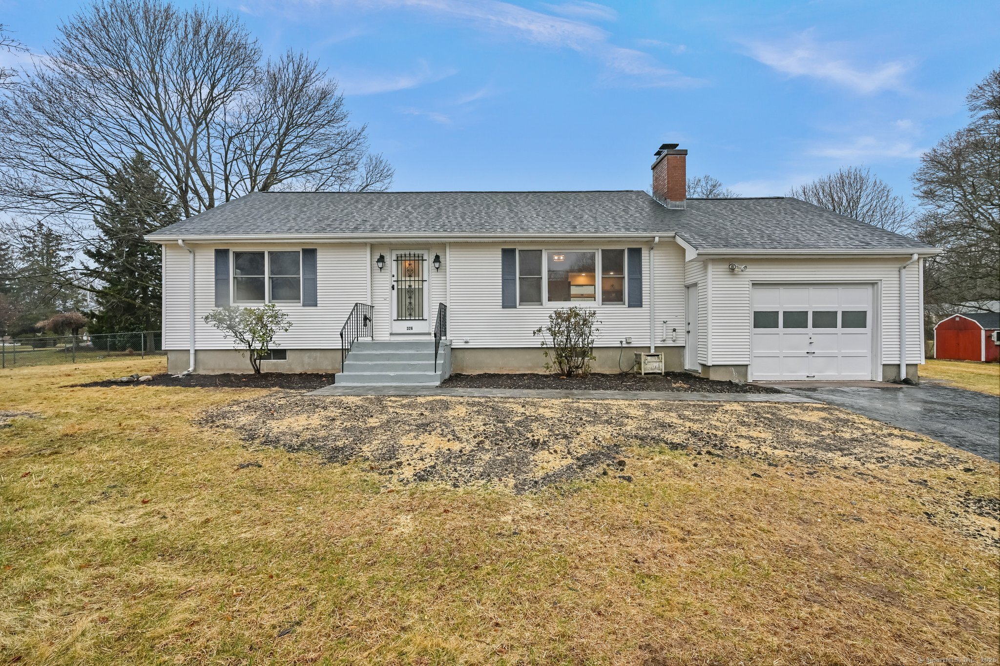 a front view of a house with two yard