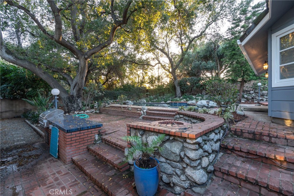 1735 Claridge Street Arcadia, CA 91006 - Photo 16 of 18 a view of a backyard with table and chairs potted plants and large tree