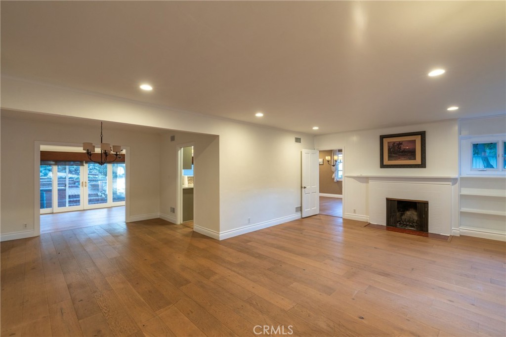 1735 Claridge Street Arcadia, CA 91006 - Photo 6 of 18 a view of an empty room with wooden floor and a fireplace