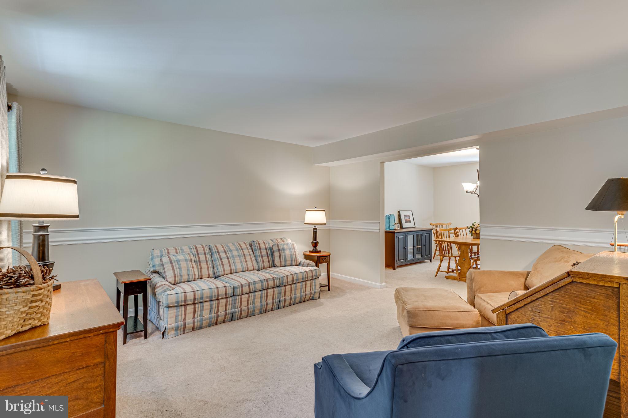 9741 Howes Road Dunkirk, MD 20754 - Photo 7 of 48 a living room with furniture and a lamp
