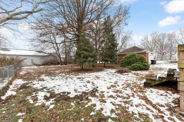 a backyard of a house with a large tree