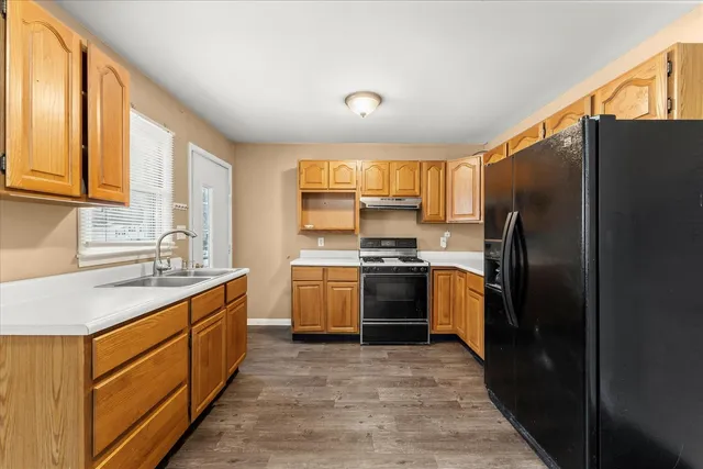 a kitchen with a refrigerator sink and stove