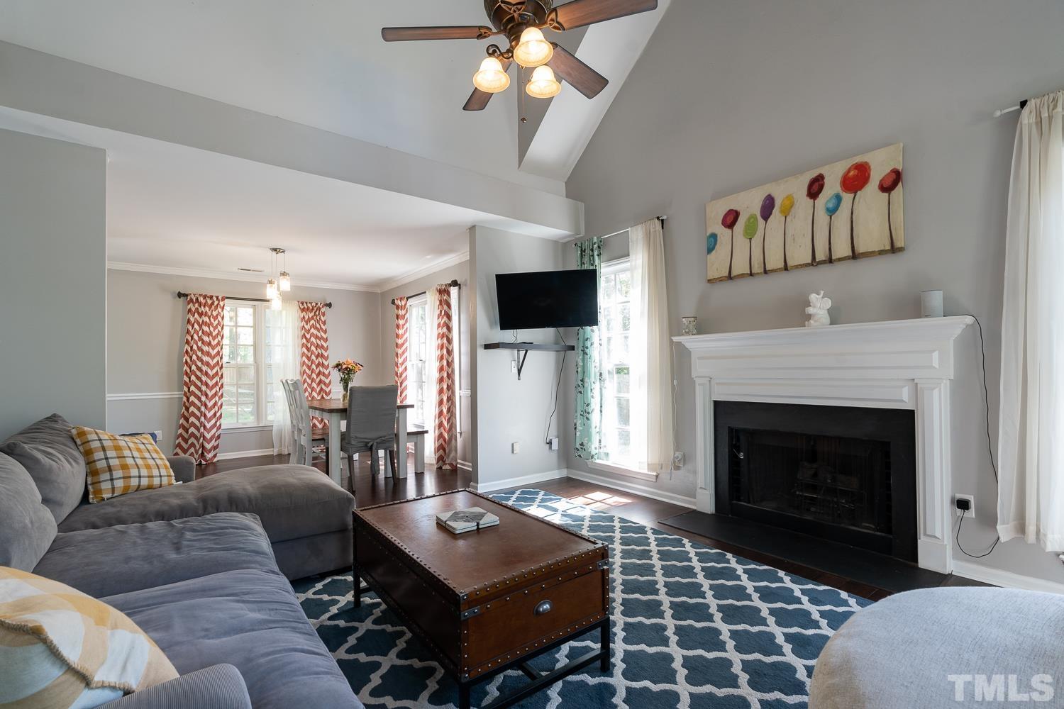 3604 Norway Court Raleigh, NC 27616 - Photo 14 of 26 a living room with furniture a flat screen tv and a fireplace