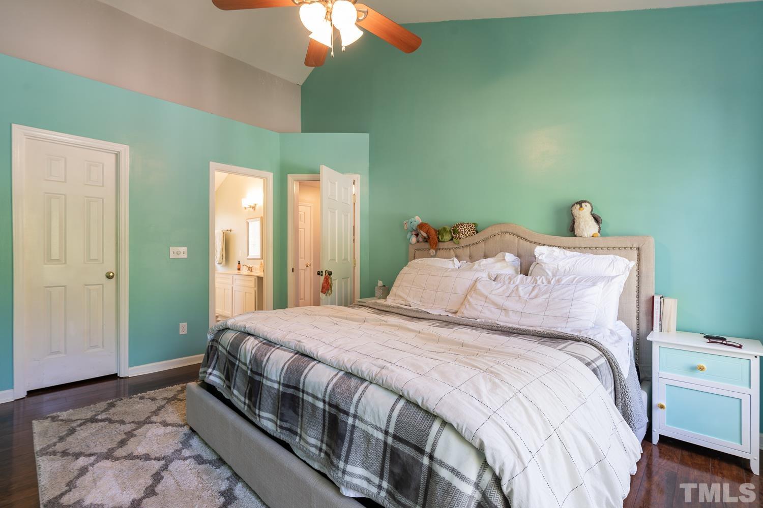 3604 Norway Court Raleigh, NC 27616 - Photo 20 of 26 a bedroom with a bed and a chandelier
