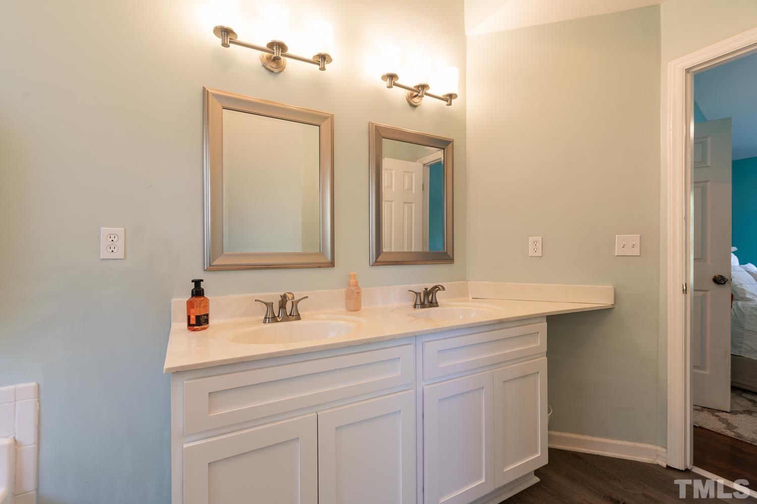 3604 Norway Court Raleigh, NC 27616 - Photo 23 of 26 a bathroom with a sink and a mirror