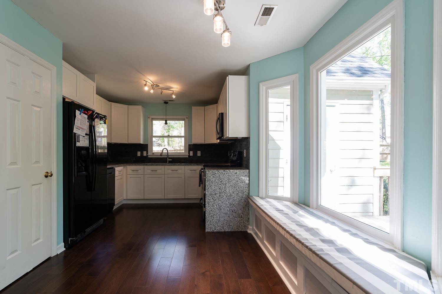 3604 Norway Court Raleigh, NC 27616 - Photo 8 of 26 a kitchen with stainless steel appliances granite countertop a refrigerator a sink dishwasher a stove and white countertops with wooden floor