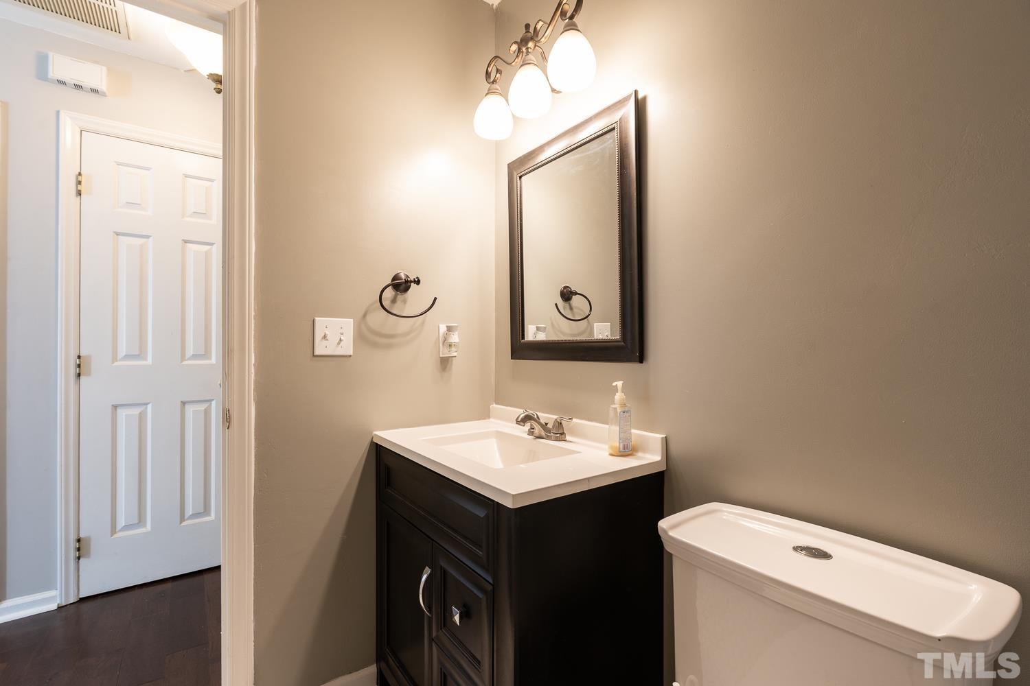 3604 Norway Court Raleigh, NC 27616 - Photo 10 of 26 a bathroom with a toilet sink and mirror