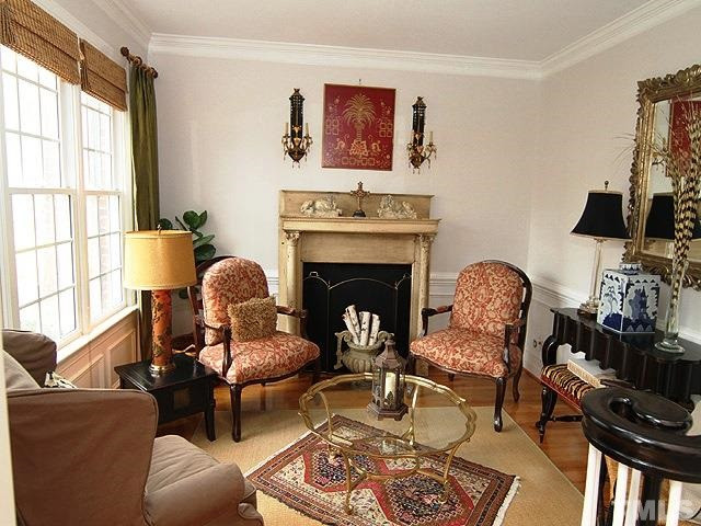 5805 Stone Spring Road Raleigh, NC 27613 - Photo 4 of 24 Light & airy living room with hardwoods, wainscoting, crown molding. living room