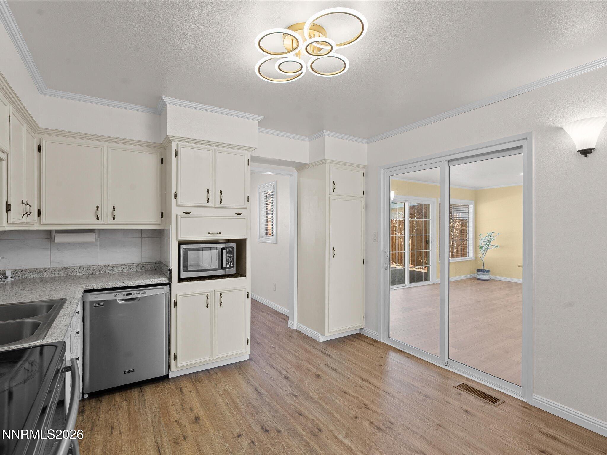 1540 Tyler Way Sparks, NV 89431 - Photo 13 of 35 a kitchen with cabinets wooden floor and a sink