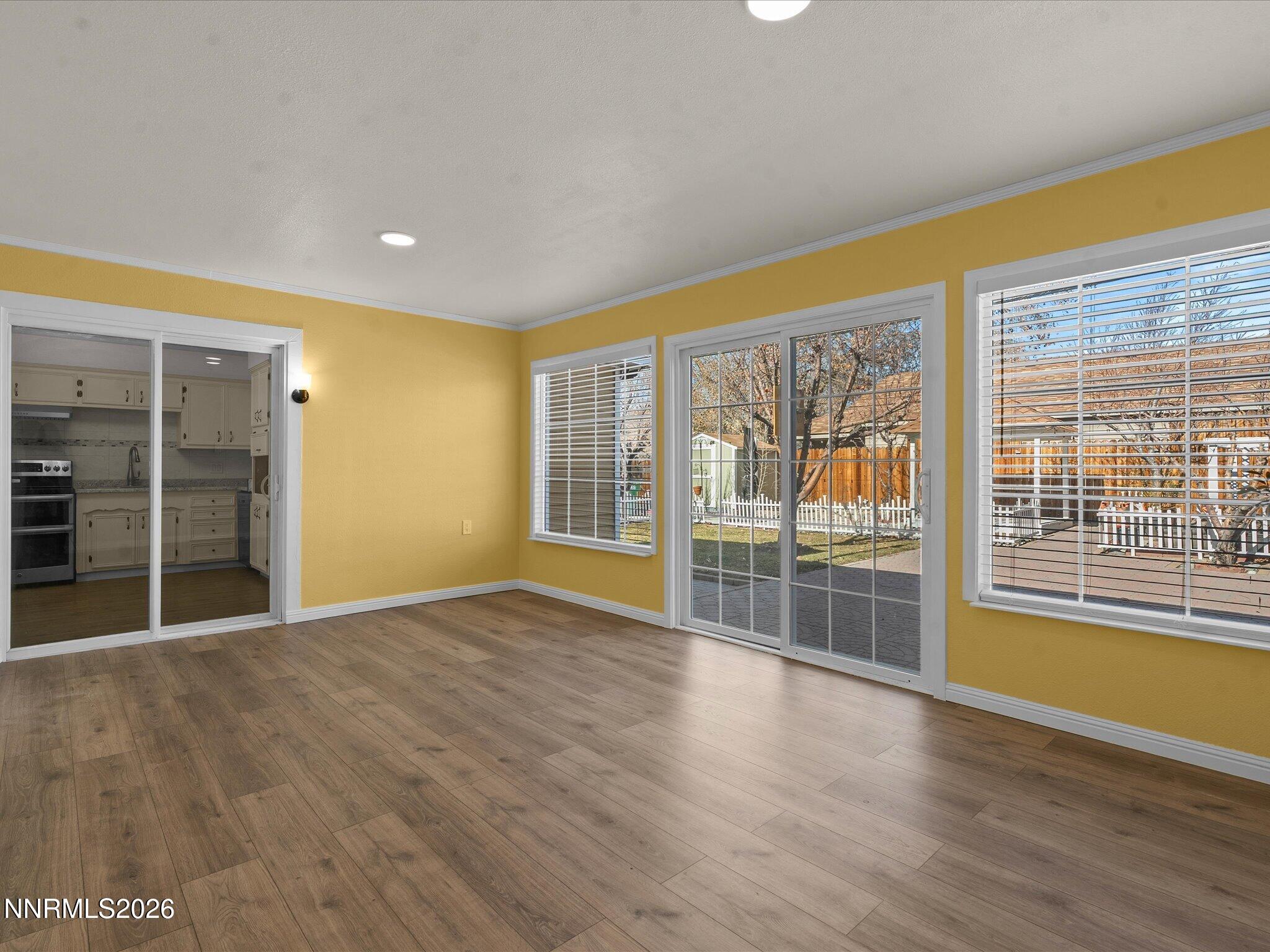1540 Tyler Way Sparks, NV 89431 - Photo 16 of 35 a view of an empty room with wooden floor and a window