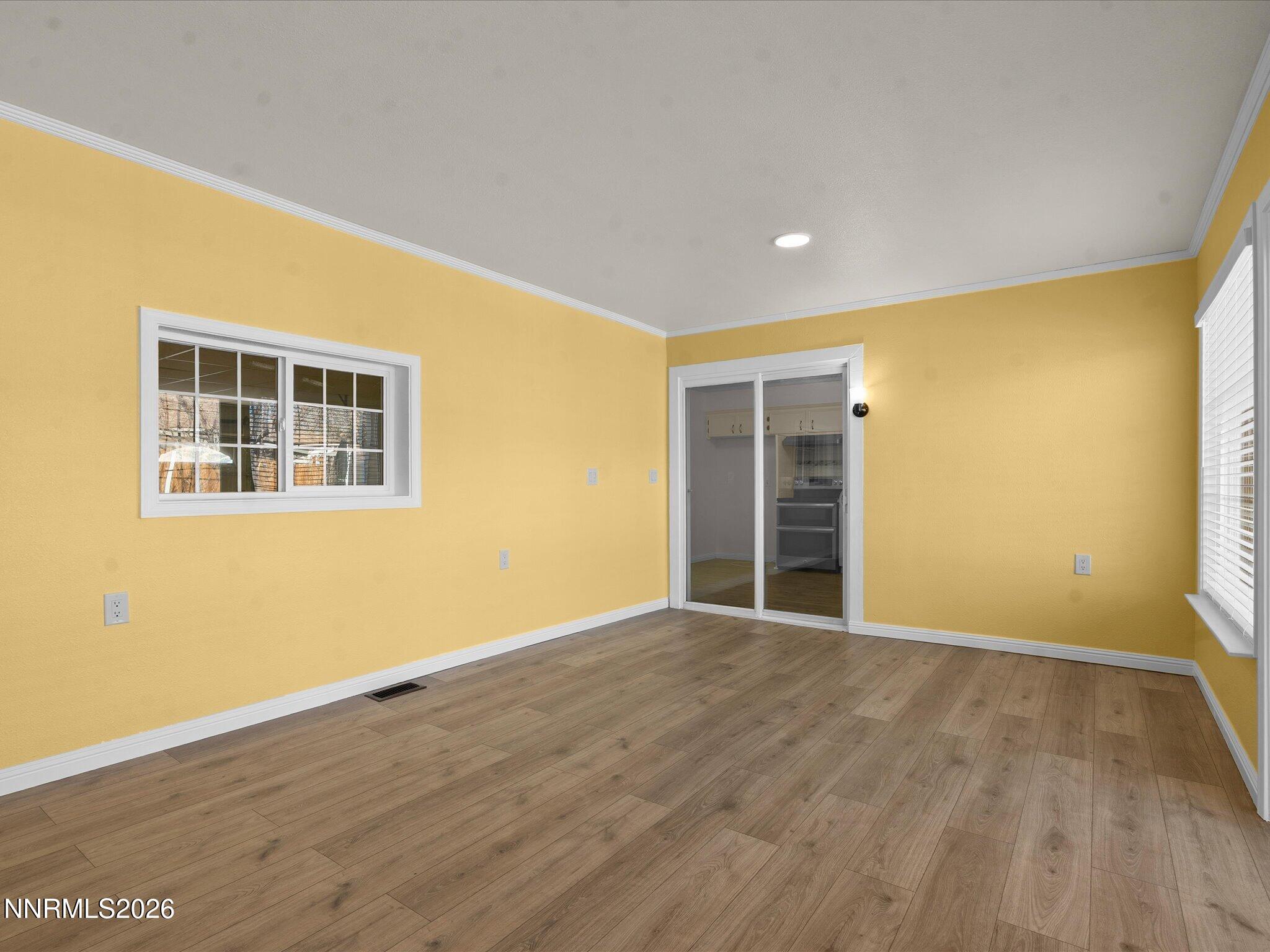 1540 Tyler Way Sparks, NV 89431 - Photo 17 of 35 a view of an empty room with wooden floor and a window