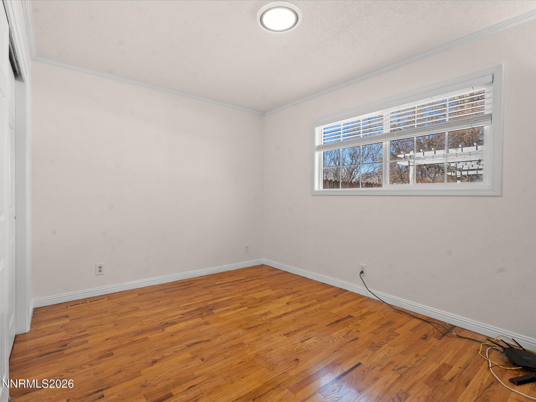 1540 Tyler Way Sparks, NV 89431 - Photo 18 of 35 a view of empty room with wooden floor